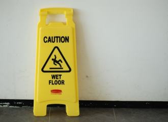 Caution wet Floor Sign leaning against a wall
